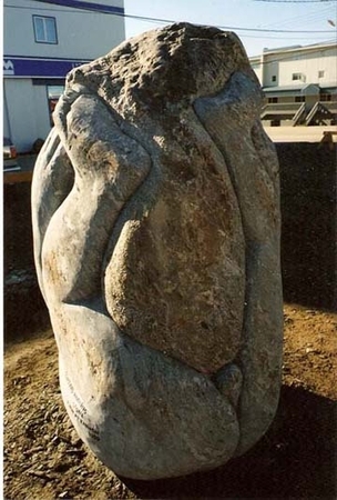 Sculptor wrestling with his stone granite..second view